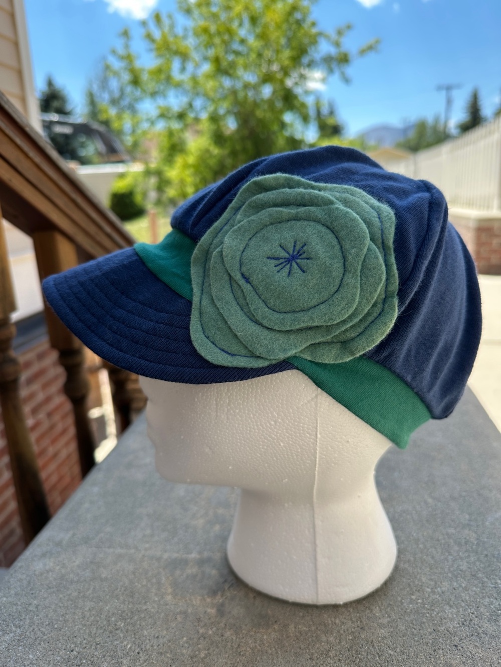 Cotton blend stretch cap baseball style hat navy green flower accent